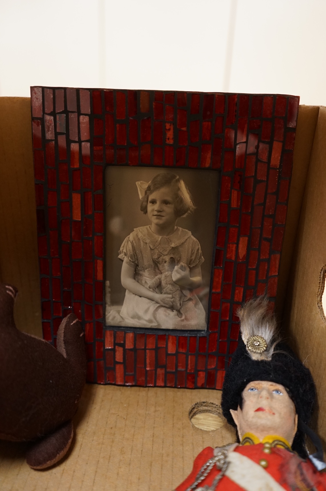An English teddy bear and related photograph, a felt Scottish guardsman and soft toy rabbit
